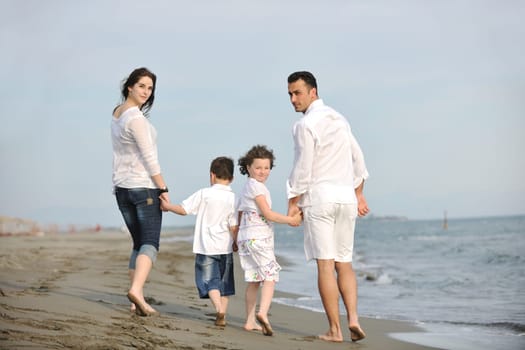 happy young family have fun and live healthy lifestyle on beach