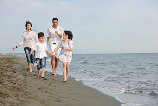 happy young family have fun and live healthy lifestyle on beach