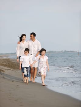 happy young family have fun and live healthy lifestyle on beach