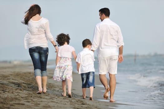 happy young family have fun and live healthy lifestyle on beach