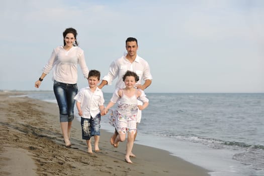 happy young family have fun and live healthy lifestyle on beach