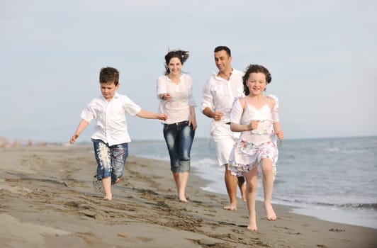 happy young family have fun and live healthy lifestyle on beach