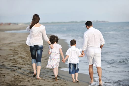 happy young family have fun and live healthy lifestyle on beach