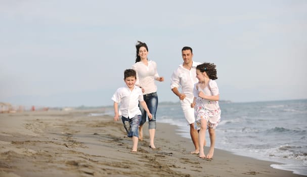happy young family have fun and live healthy lifestyle on beach