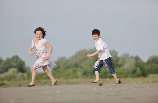 happy young family have fun and live healthy lifestyle on beach