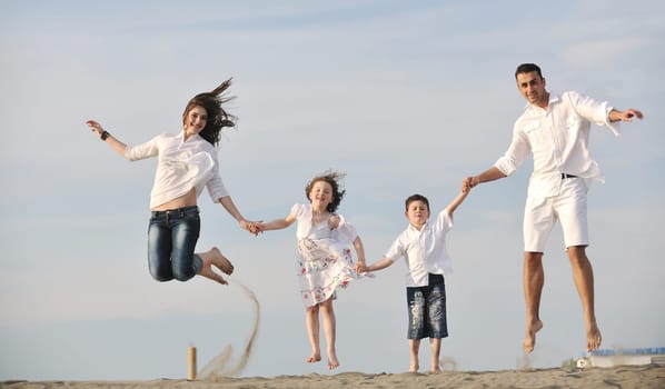 happy young family have fun and live healthy lifestyle on beach