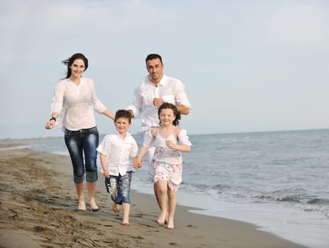 happy young family have fun and live healthy lifestyle on beach