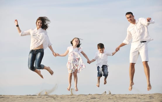 happy young family have fun and live healthy lifestyle on beach