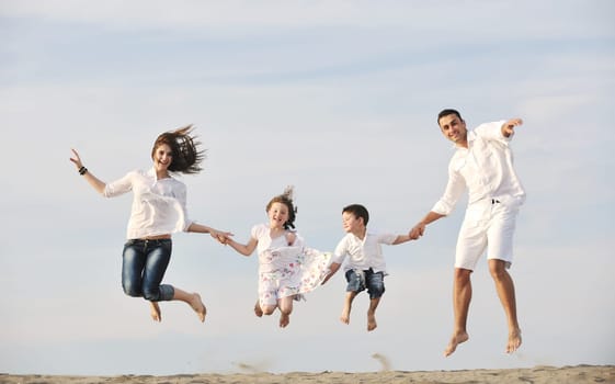 happy young family have fun and live healthy lifestyle on beach