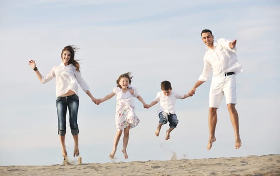 happy young family have fun and live healthy lifestyle on beach
