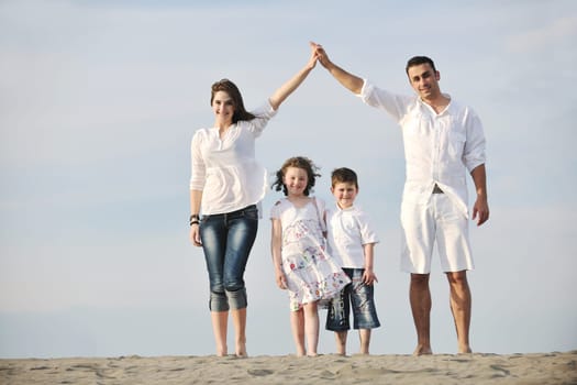 happy young family have fun and live healthy lifestyle on beach