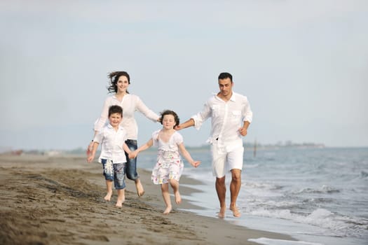 happy young family have fun and live healthy lifestyle on beach