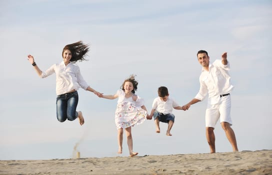 happy young family have fun and live healthy lifestyle on beach