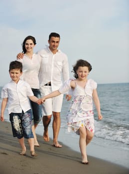 happy young family have fun and live healthy lifestyle on beach