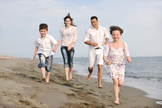 happy young family have fun and live healthy lifestyle on beach