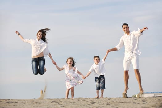 happy young family have fun and live healthy lifestyle on beach