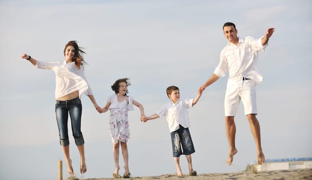 happy young family have fun and live healthy lifestyle on beach