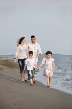 happy young family have fun and live healthy lifestyle on beach