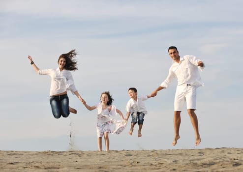 happy young family have fun and live healthy lifestyle on beach