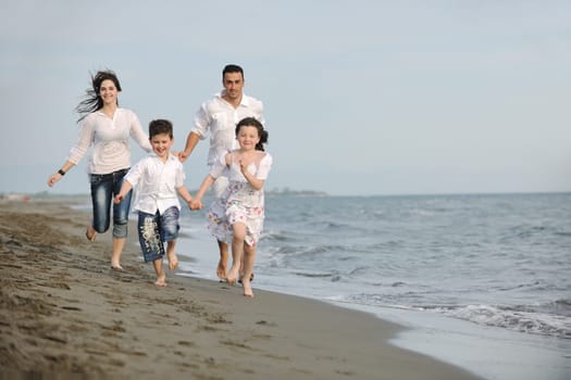 happy young family have fun and live healthy lifestyle on beach