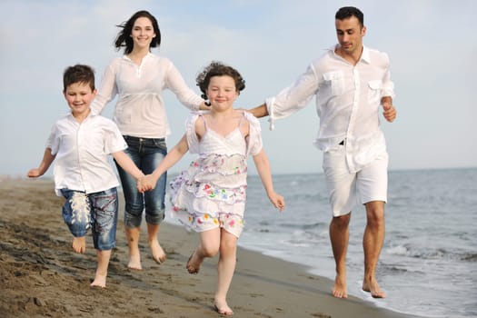 happy young family have fun and live healthy lifestyle on beach