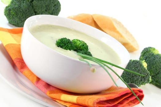 a bowl of broccoli cream soup with fresh vegetables