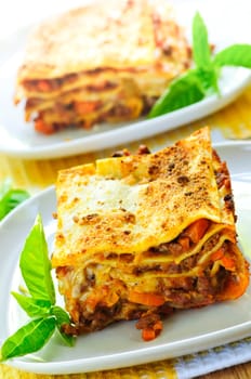 Two servings of fresh baked lasagna on plates