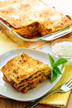 Fresh baked lasagna casserole with a serving cut