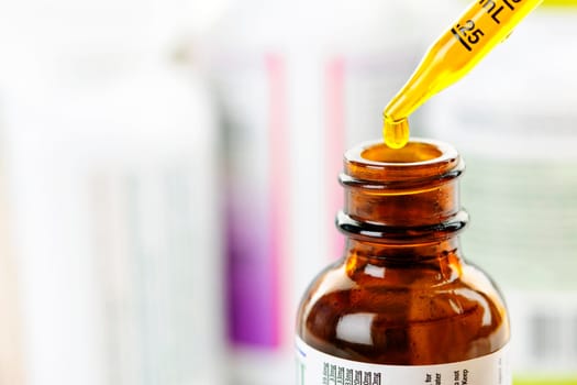 Closeup of liquid medicine in glass dropper and bottle