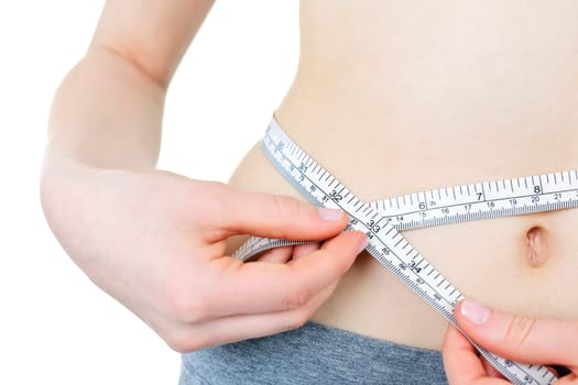 Fit young woman measuring waist with tape