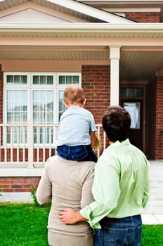 Young happy family shopping for new home