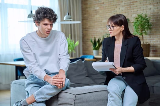 Young guy in therapy session discussing his emotional problems with female psychotherapist. Psychological assistance services, mental health, counseling, support, psychotherapy, psychology concept