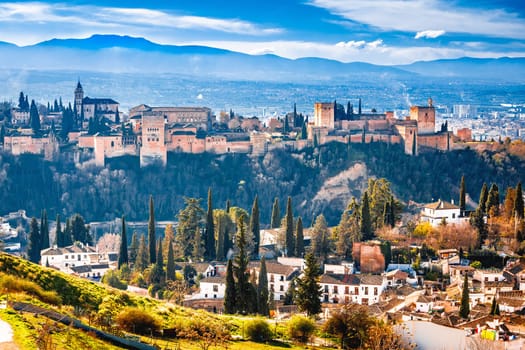 Ancient Alhambra and Sierra Nevada mountain view, UNESCO world heritage site in Granada, Andalusia region of Spain