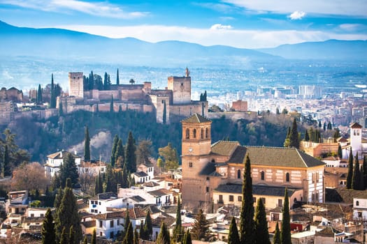 Ancient Alhambra and Sierra Nevada mountain view, UNESCO world heritage site in Granada, Andalusia region of Spain