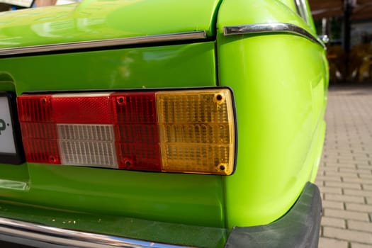 the rear light of an old classic car is light green. Details of retro cars. close-up and attention to detail. Brake light, reversing lamp, size lamp and turn indicators