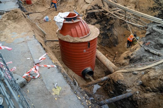 installation of the city sewer system. Collection of sewage and rainwater. The caisson is buried in the ground. Wiring of sewer pipes