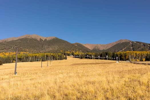 Humphreys Peak in Flagstaff, Arizona. San Francisco Peaks Landscape in Fall Season on Blue Sky. Scenic Climbing, Hiking and Mountaineering in Autumn Season. Horizontal Plane. High quality photo