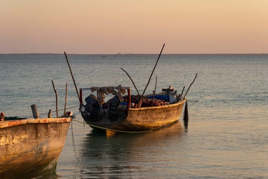 Fishing wooden boats moored on the beach due to low tide at sunset, Zanzibar,Tanzania Africa