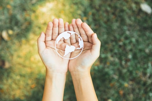 Top view hand holding Earth planet icon symbolize eco-friendly commitment to environmental protection and zero carbon emission. Earth World Day concept to promote eco awareness. Gyre