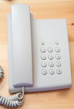 White telephone on the table of wood