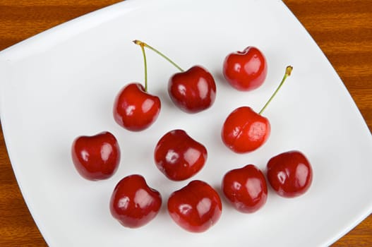 Photo of red cherries in a white plate