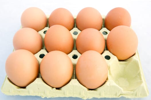 Chicken eggs in a box a over white background