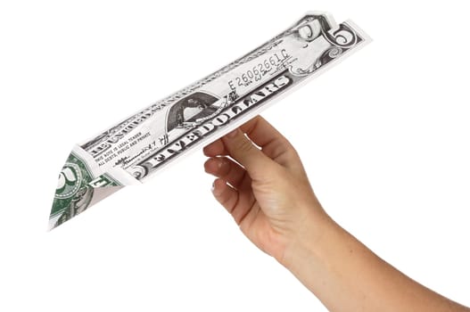 bill of five dollars turned a paper airplane a over white background