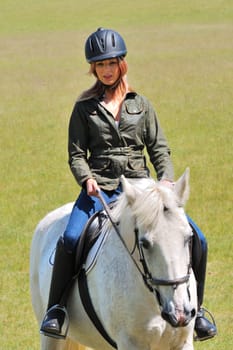Girl riding white horse