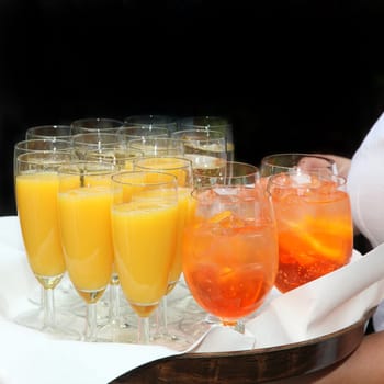 Sparkling wine,orange juice and cocktails served by the waiter - square