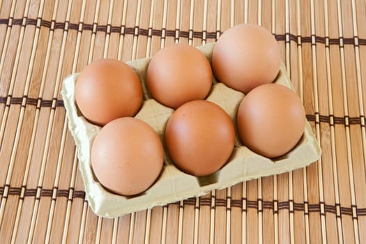 Photo of half dozen eggs on bamboo tablecloth
