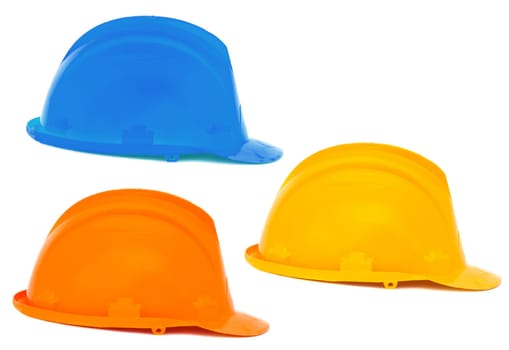 Three helmets a over white background , blue, orange, yellow