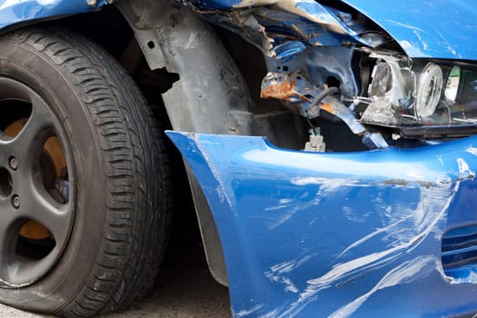 Accident with sheet metal damage,dented car stands on the road