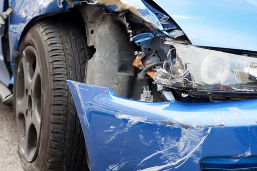Accident with sheet metal damage,dented car stands on the road