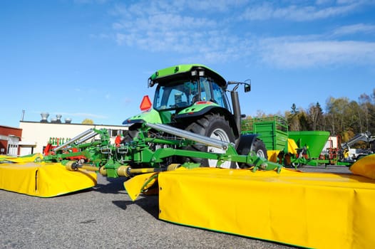 giant tractor with mowers on each side ( NOT! john-deer colors)and no trademarks visible.